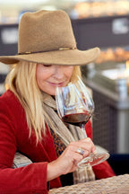 Woman smelling glass of red wine featuring 2021 HALL Exzellenz Cabernet Sauvignon