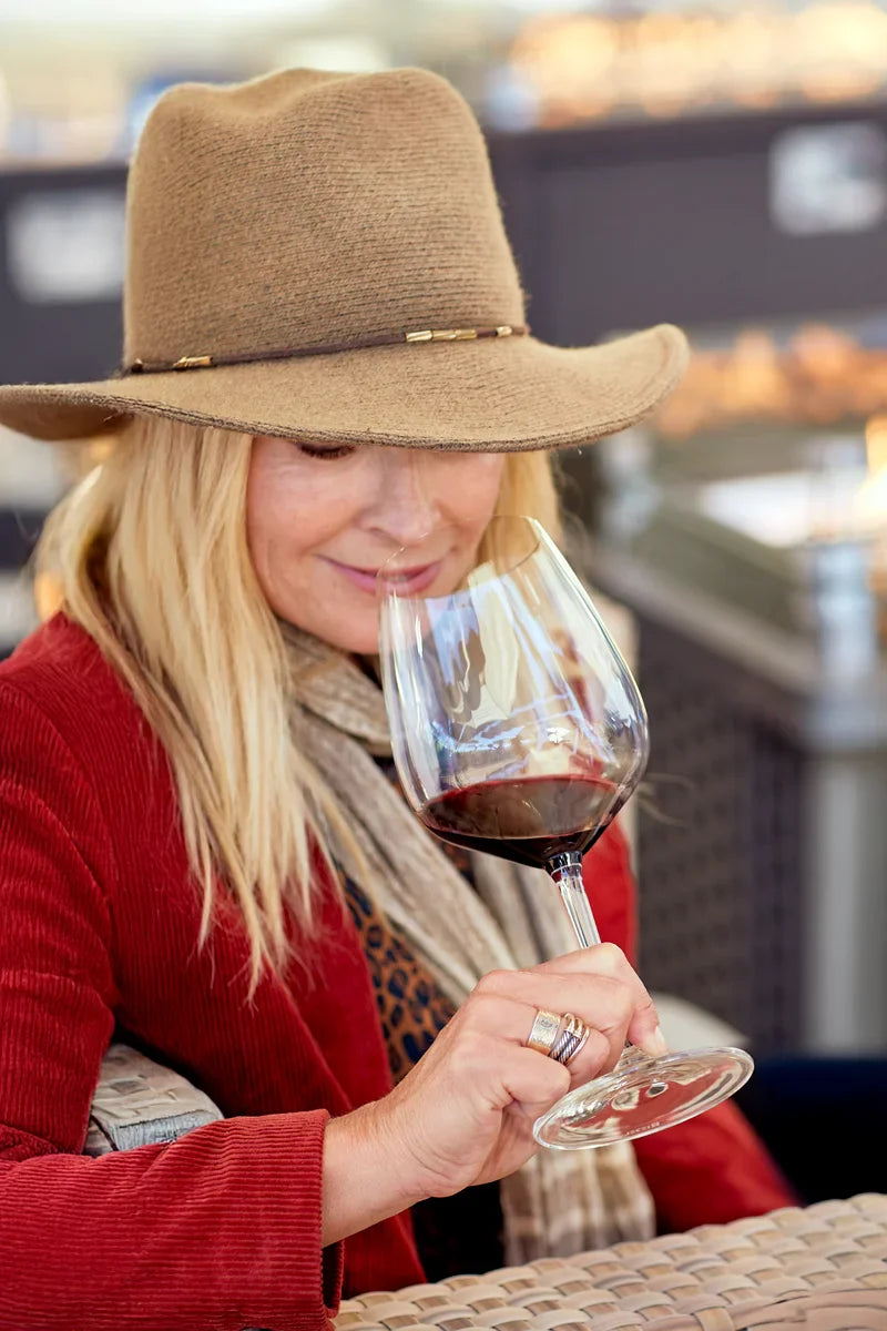Woman smelling glass of red wine featuring 2019 HALL Exzellenz Cabernet Sauvignon